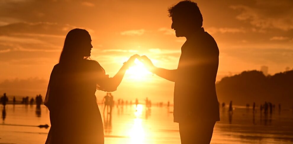 couple enjoying sunset at radhanagar beach